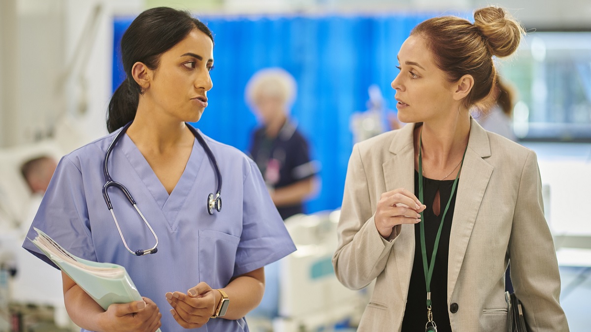 administrator A clinic administrator talks to a doctor