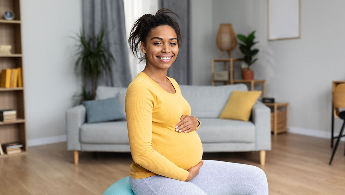 Asian pregnant woman smiling pregnant person sitting down