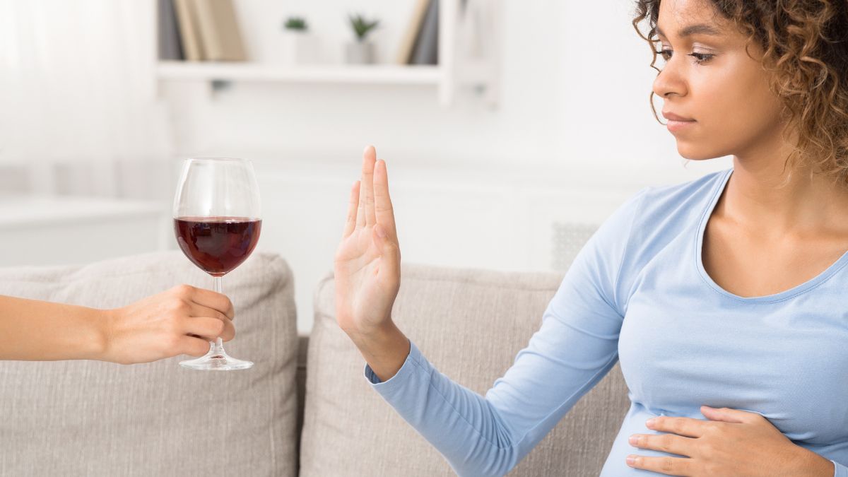 — title missing — Pregnant woman refusing a glass of wine