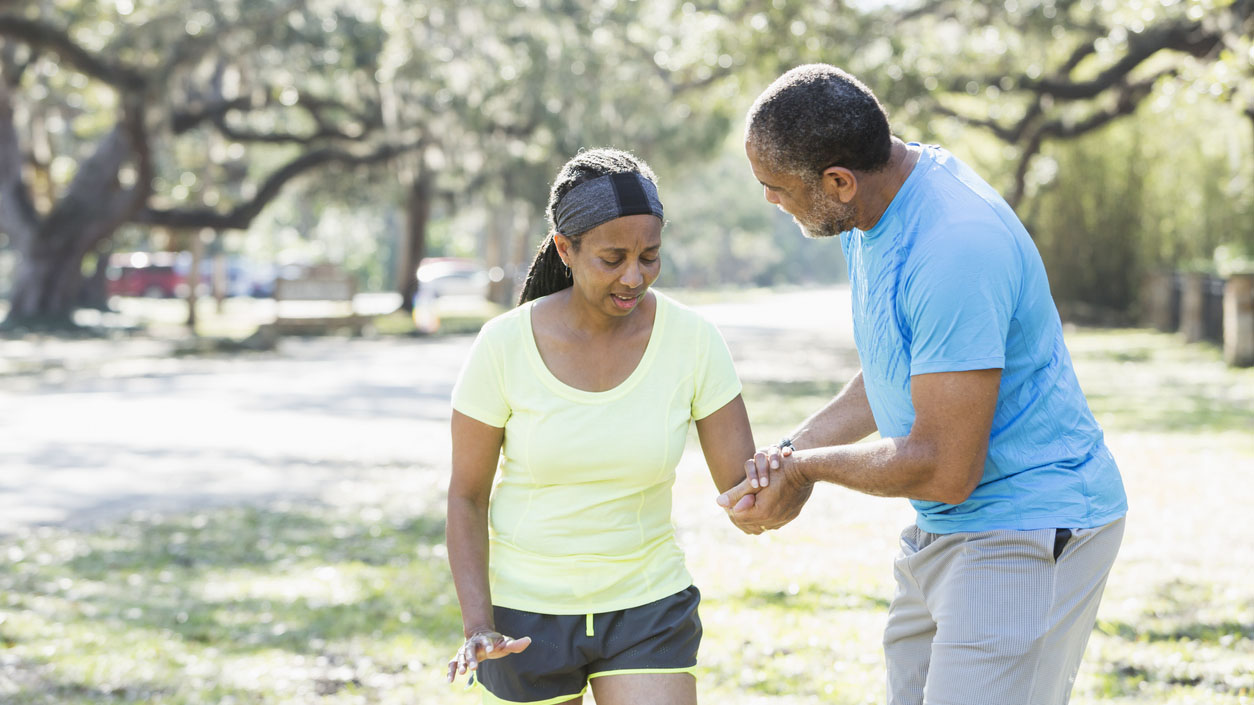 A man helping a woman walk safely on the street A man helping a woman walk safely on the street