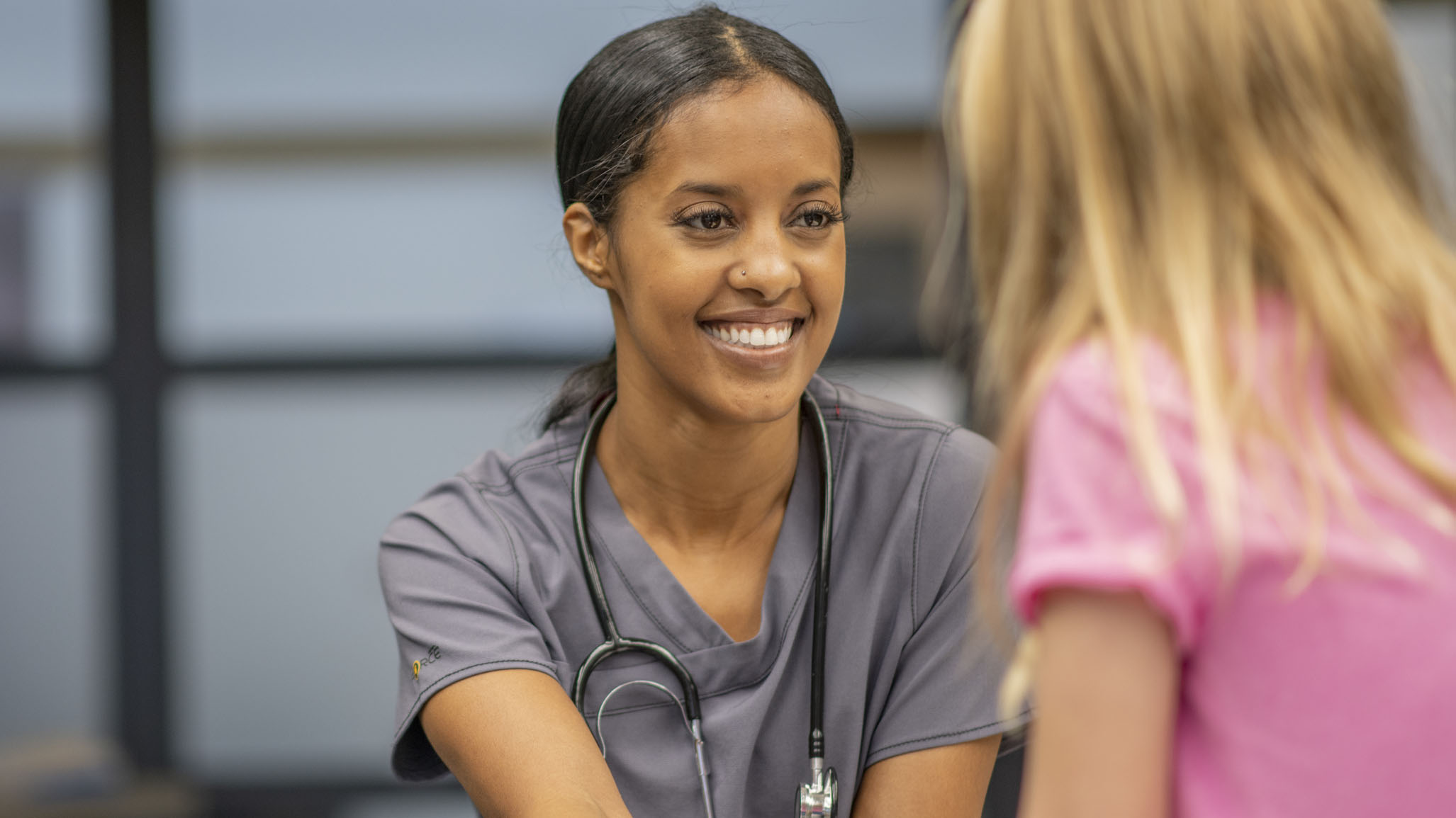 A young girl visits the school nurse.